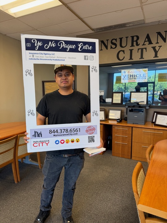Insurance City Stockton customer next to California vehicle registration counter — no broker fee charged